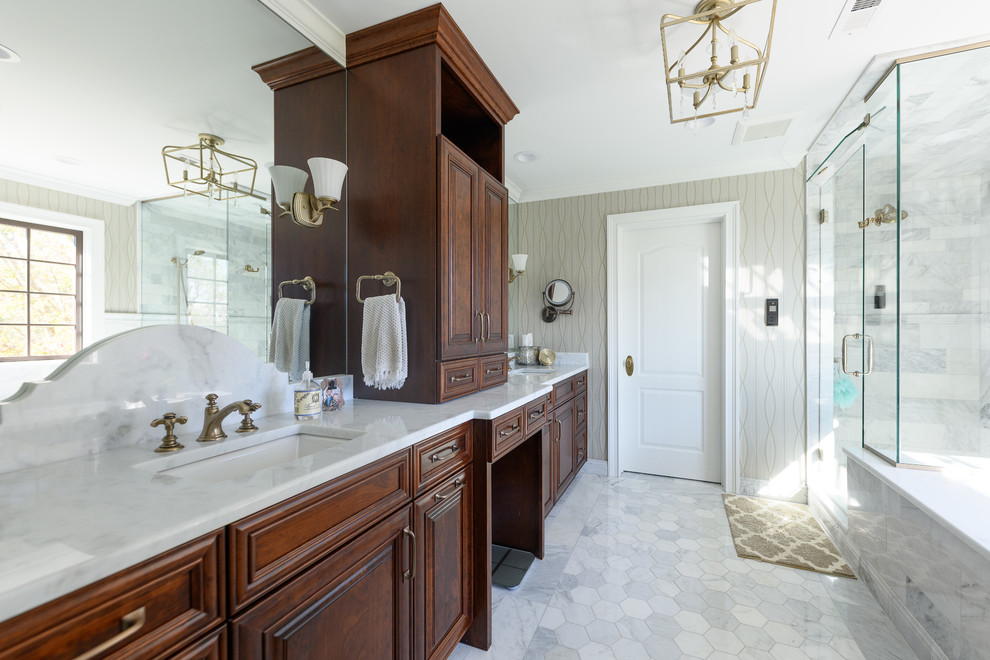 Example of a mid-sized transitional master white tile and marble tile marble floor and white floor corner shower design with raised-panel cabinets, dark wood cabinets, an undermount tub, gray walls, an undermount sink, quartzite countertops, a hinged shower door and white countertops