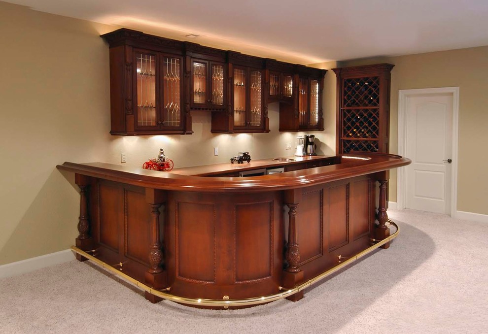 This is an example of a mid-sized traditional home bar in Other.