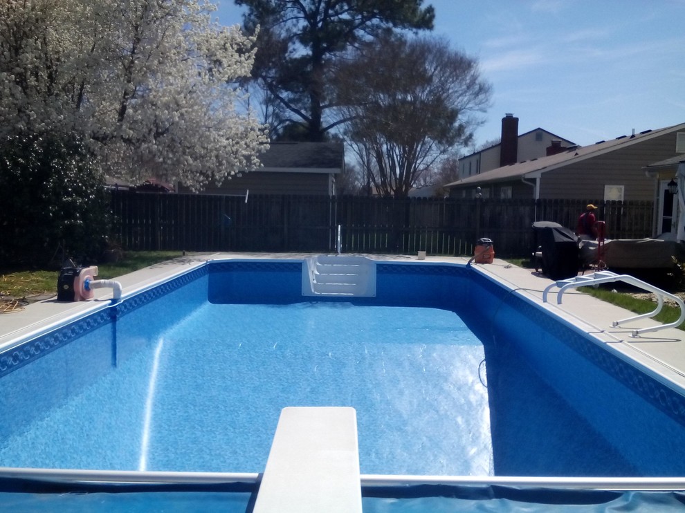 Mid-sized backyard concrete paver and custom-shaped natural pool photo