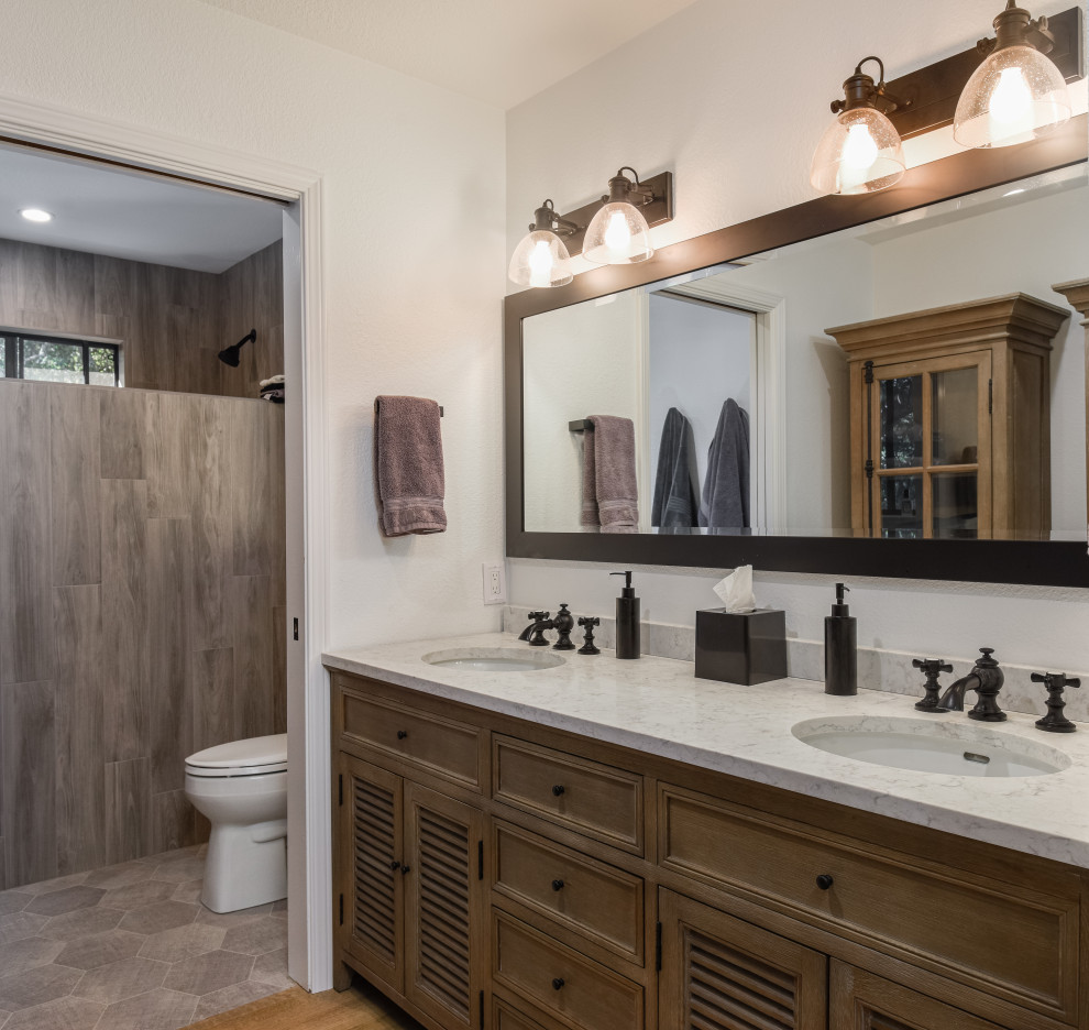 Inspiration for a transitional 3/4 bathroom in San Francisco with louvered cabinets, medium wood cabinets, brown tile, wood-look tile, white walls, medium hardwood floors, an undermount sink, brown floor, multi-coloured benchtops, an enclosed toilet, a double vanity and a built-in vanity.