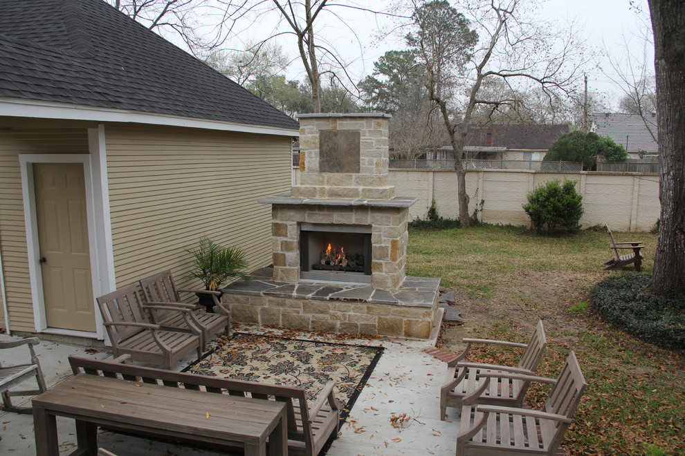 Photo of a large country backyard patio in Houston with a fire feature and concrete slab.