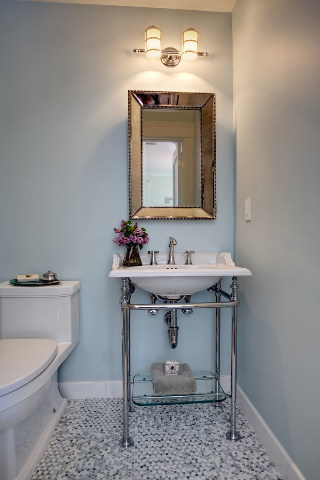 Photo of a small beach style 3/4 bathroom in San Francisco with a pedestal sink, a two-piece toilet, blue walls, mosaic tile floors, recessed-panel cabinets, white cabinets, an undermount tub, a shower/bathtub combo and marble benchtops.