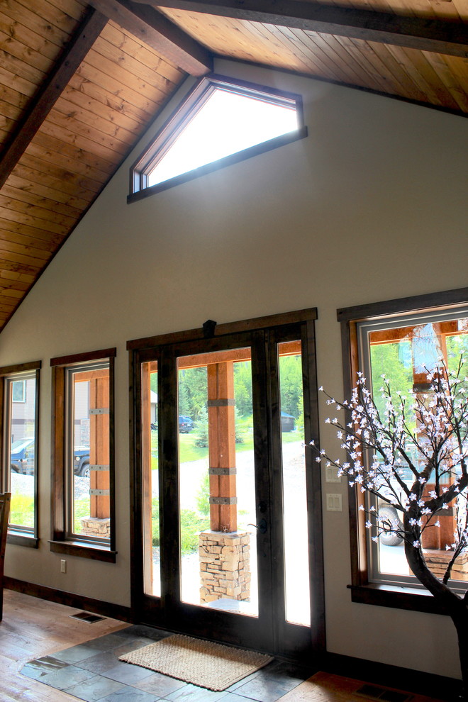 Front door - large transitional slate floor and brown floor front door idea with beige walls and a glass front door