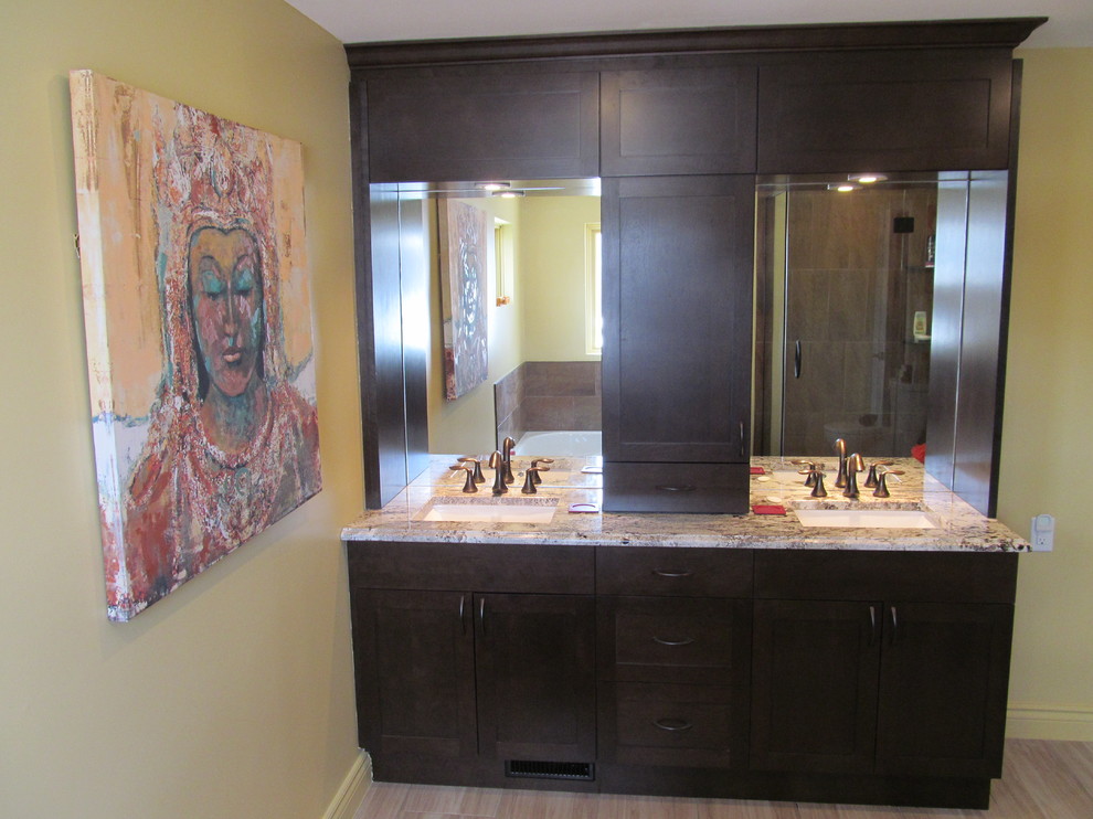 Mid-sized contemporary master bathroom in Ottawa with shaker cabinets, black cabinets, a hot tub, a corner shower, a two-piece toilet, brown tile, slate, yellow walls, porcelain floors, an undermount sink, granite benchtops, beige floor, a hinged shower door and multi-coloured benchtops.