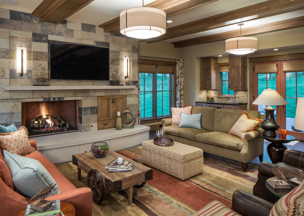 Photo of a large country open concept family room in Omaha with dark hardwood floors, a standard fireplace, a tile fireplace surround and a wall-mounted tv.