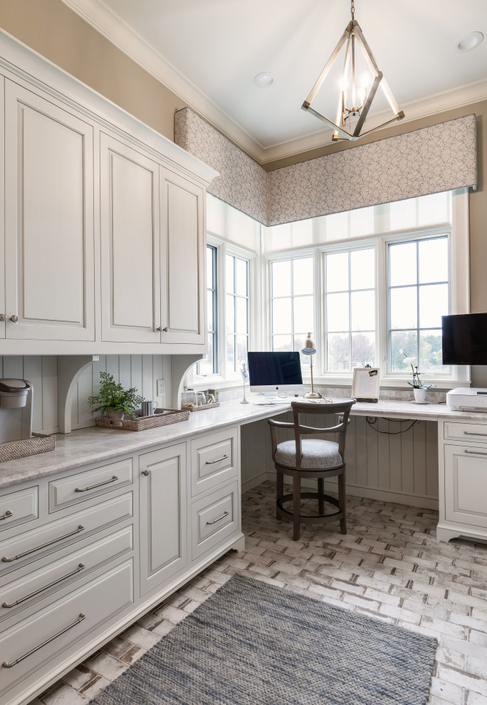 Home office in Grand Rapids with beige walls, ceramic floors, a built-in desk, white floor and planked wall panelling.