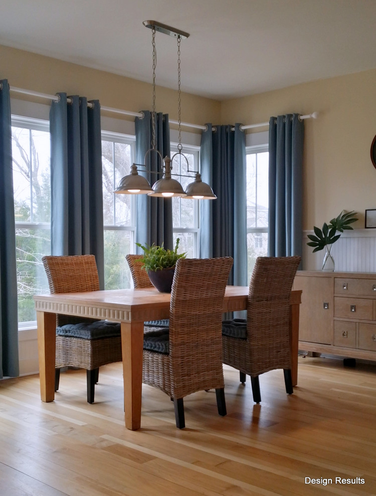 Immagine di una grande sala da pranzo aperta verso il soggiorno stile marinaro con parquet chiaro