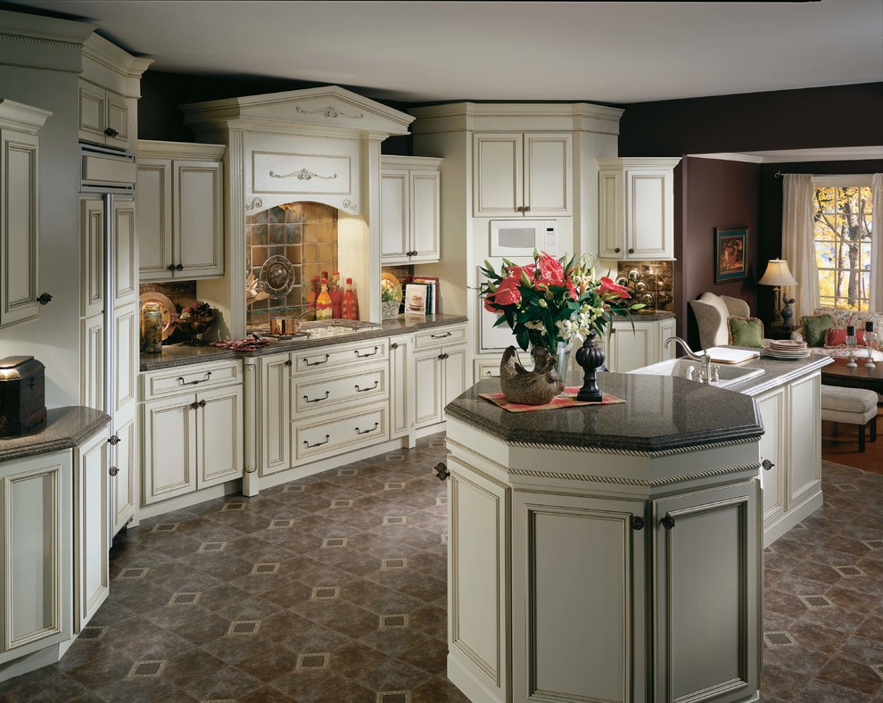 Photo of a traditional kitchen in Phoenix with a drop-in sink, recessed-panel cabinets, white cabinets and panelled appliances.
