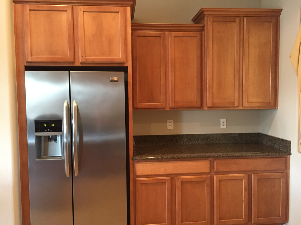 Example of a mid-sized transitional kitchen design in Phoenix with recessed-panel cabinets, stainless steel appliances and an island