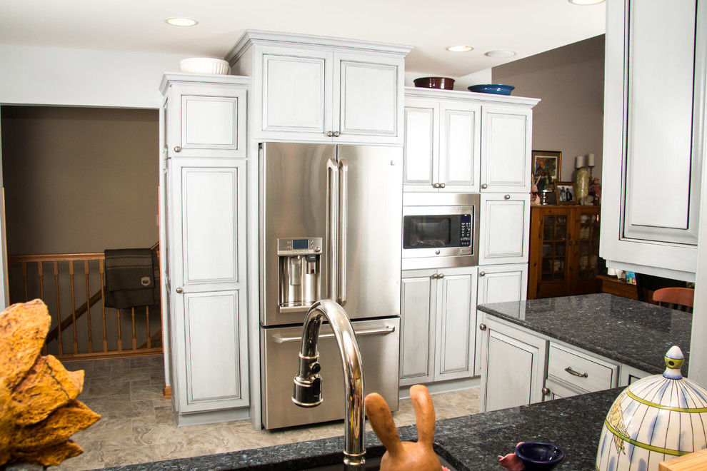Eat-in kitchen - large transitional u-shaped porcelain tile and beige floor eat-in kitchen idea in Milwaukee with an undermount sink, raised-panel cabinets, gray cabinets, granite countertops, white backsplash, marble backsplash, stainless steel appliances and no island