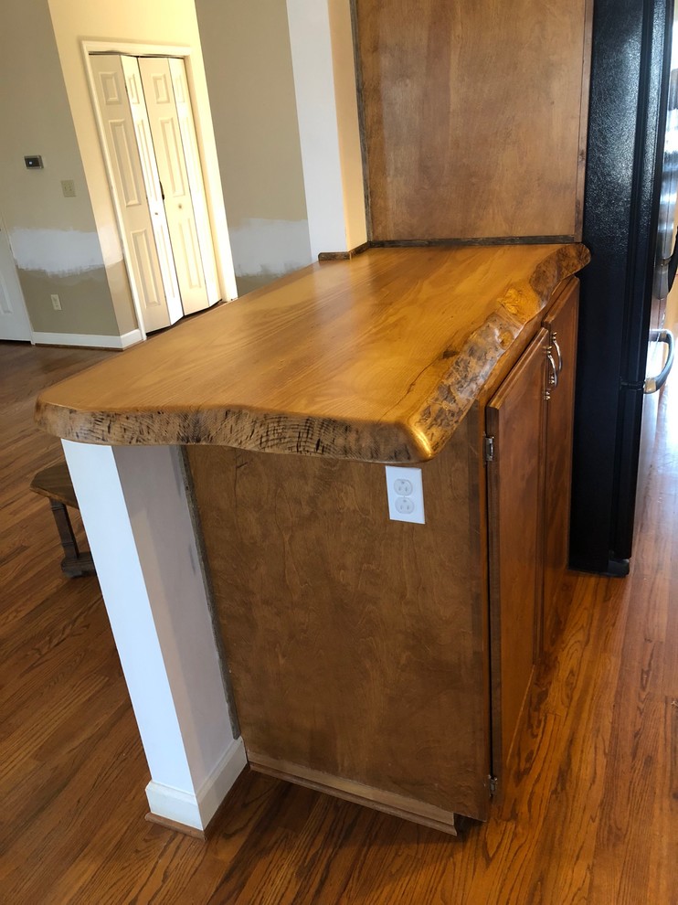 Inspiration for a mid-sized rustic l-shaped home design remodel with wood countertops and brown countertops
