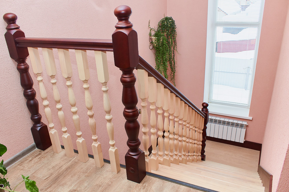 Inspiration for a wood u-shaped staircase in Other with wood risers and wood railing.