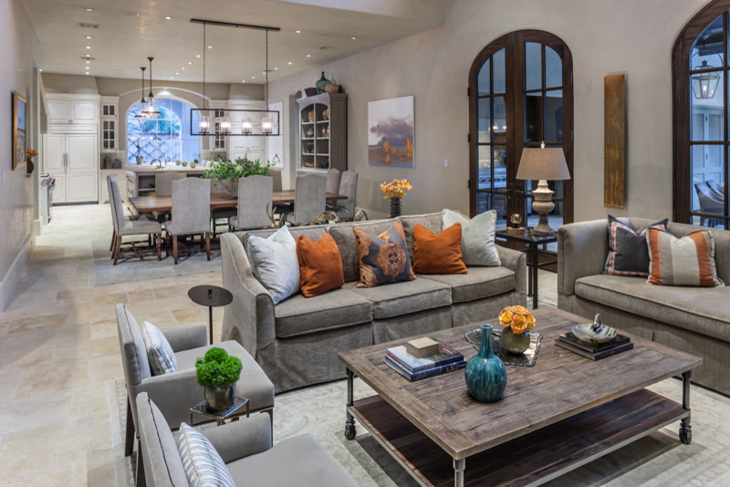 Photo of a large mediterranean formal open concept living room in Houston with grey walls, travertine floors, a standard fireplace, a stone fireplace surround and no tv.