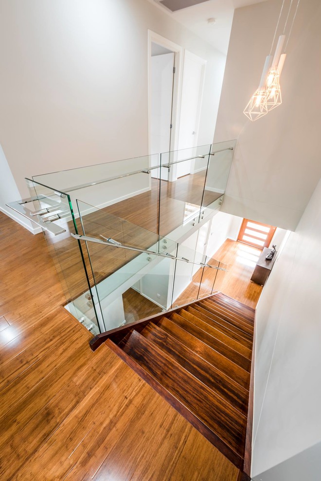 Design ideas for a contemporary wood straight staircase in Brisbane with wood risers.