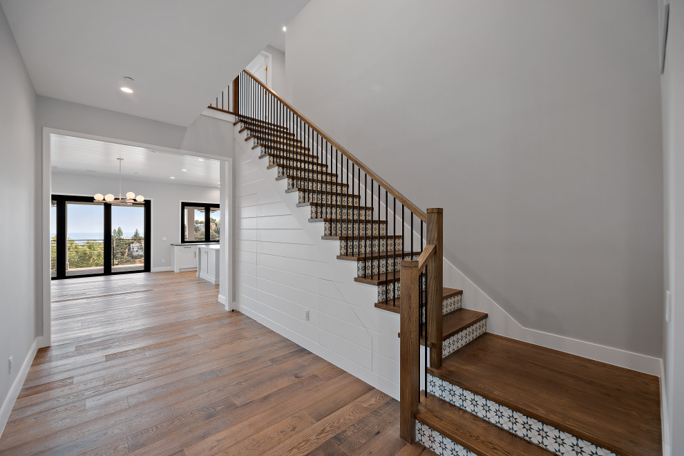 Inspiration for an expansive country tile l-shaped staircase in Los Angeles with wood risers and metal railing.
