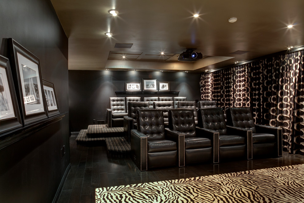 Inspiration for a contemporary enclosed home theatre in New York with black walls, a projector screen and black floor.