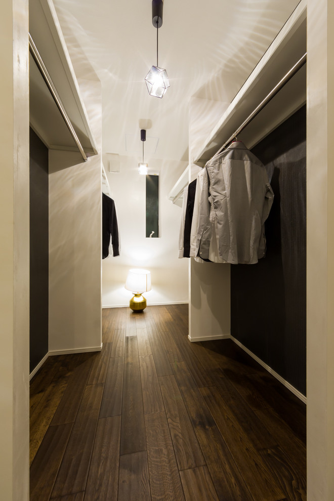 Design ideas for a contemporary walk-in wardrobe in Other with dark hardwood floors and brown floor.