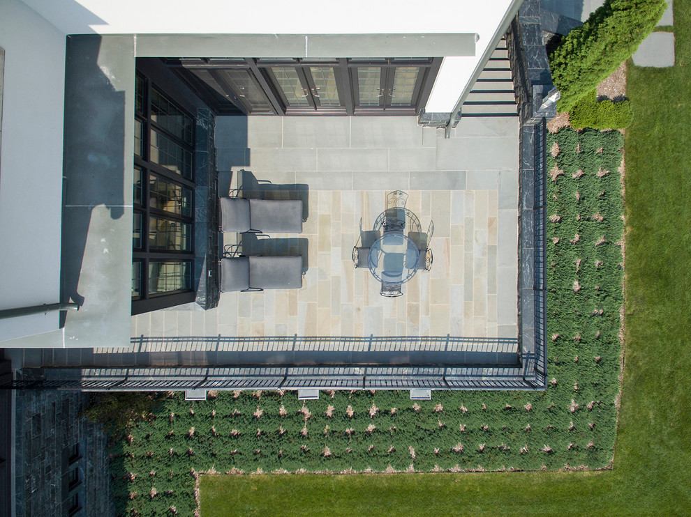 Photo of a transitional backyard stone landscaping in Minneapolis.