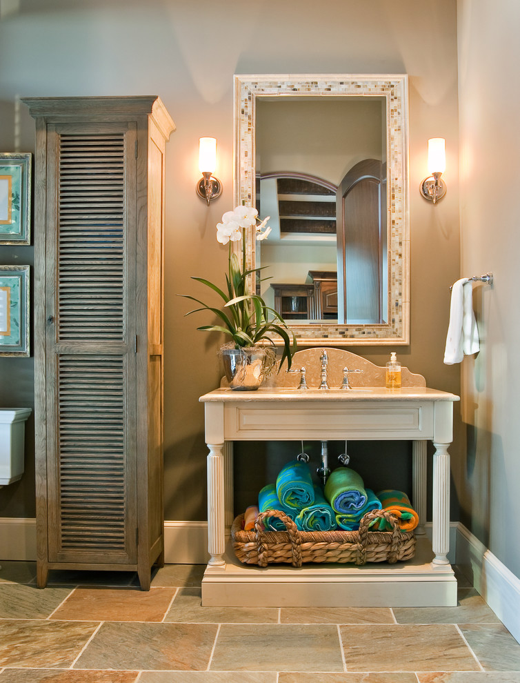 Inspiration for a traditional bathroom in Charleston with stone tile, grey walls, light wood cabinets and open cabinets.