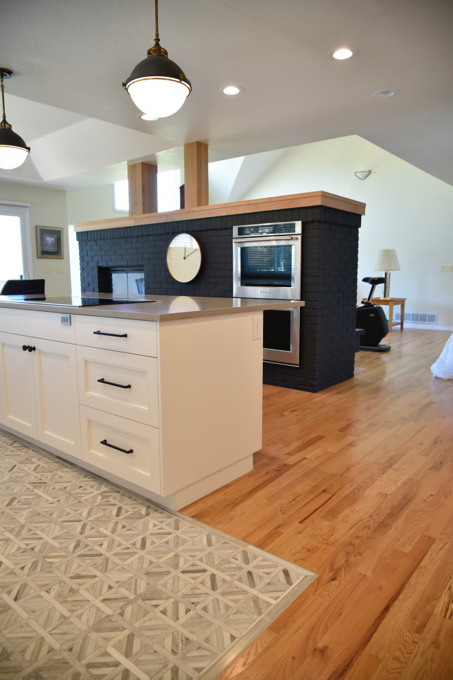 Mid-sized transitional single-wall porcelain tile, beige floor and coffered ceiling eat-in kitchen photo in Denver with an undermount sink, shaker cabinets, beige cabinets, quartz countertops, beige backsplash, cement tile backsplash, stainless steel appliances, an island and beige countertops