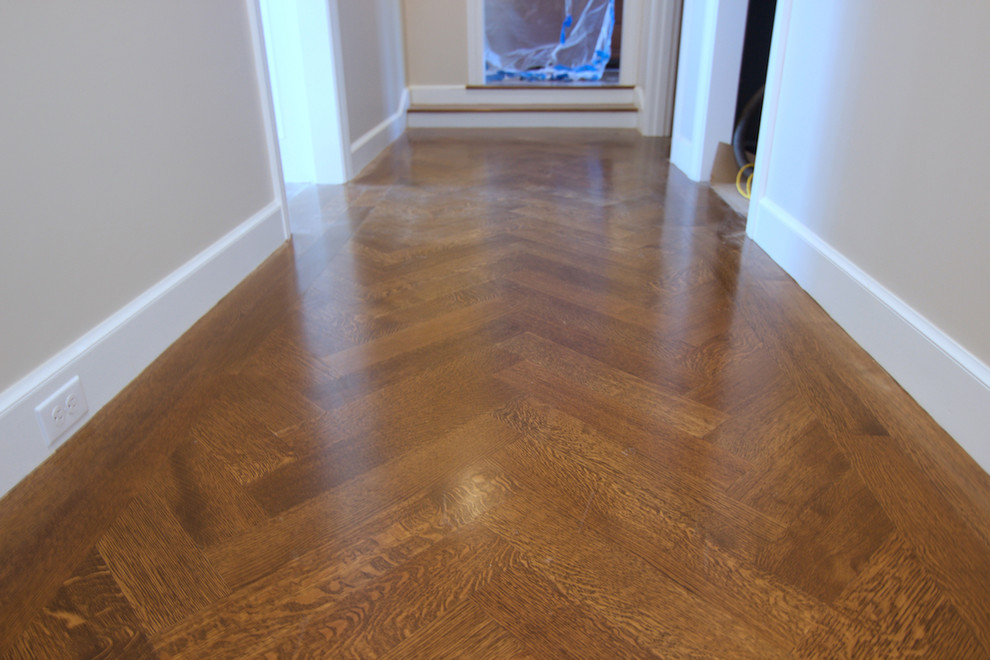 Photo of a large traditional hallway in Boston with dark hardwood floors and brown floor.