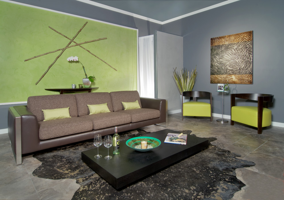 This is an example of a contemporary living room in Miami with green walls and slate floors.