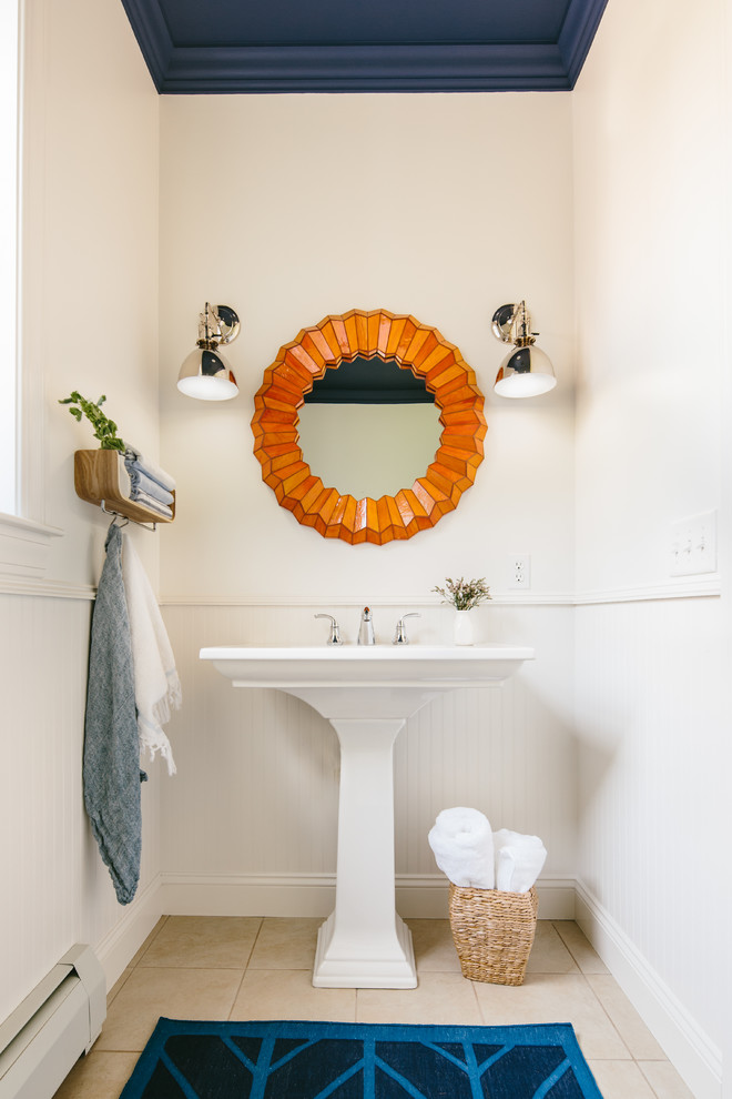 Photo of a transitional powder room in Other with a pedestal sink and white walls.