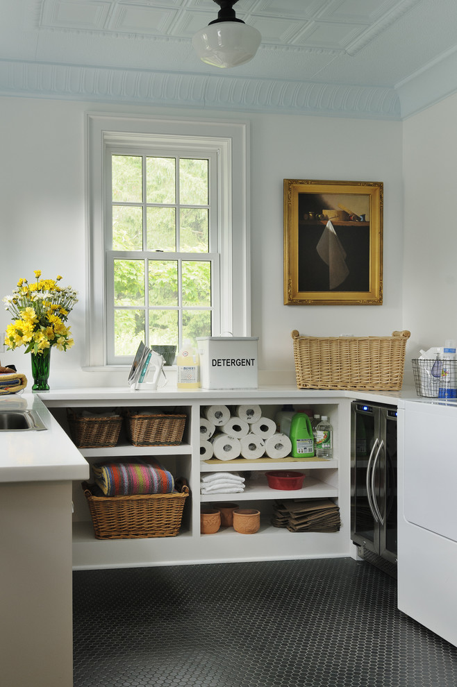 Design ideas for a traditional laundry room in New York with open cabinets, white cabinets, white walls, black floor and white benchtop.