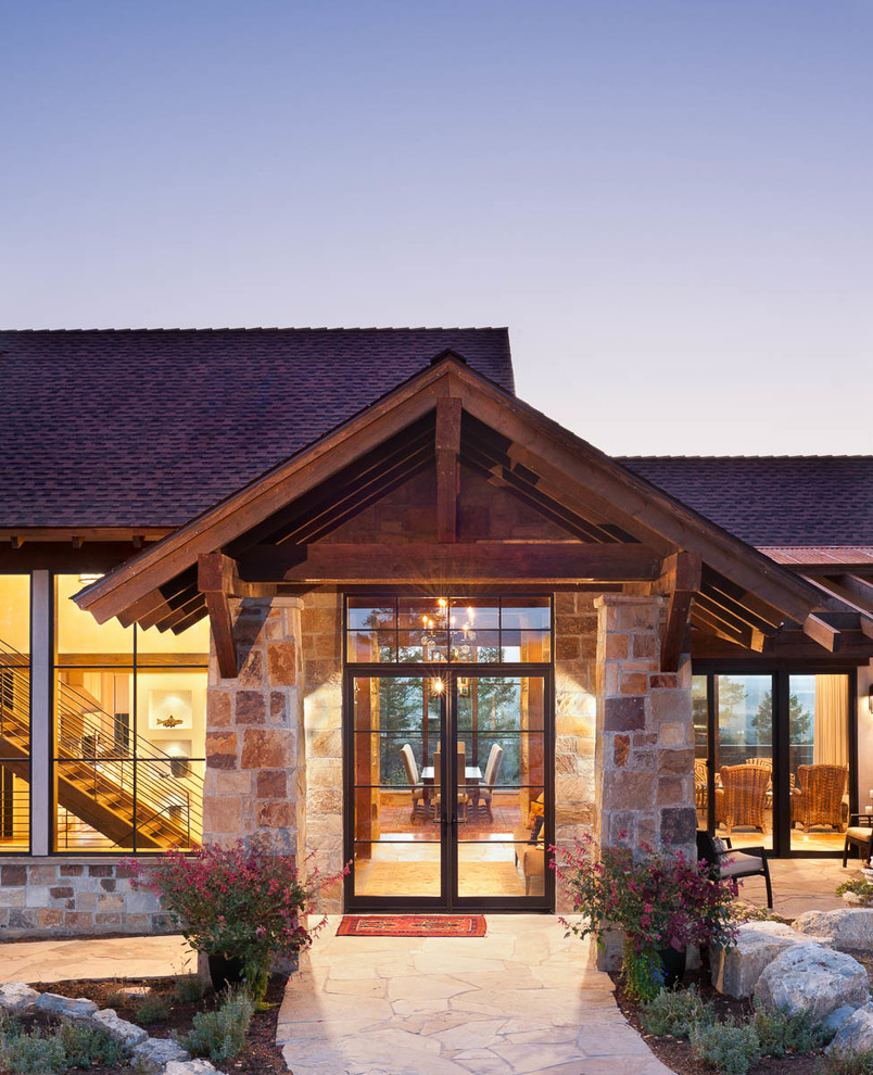 This is an example of a large country entryway in Other with a double front door and a glass front door.