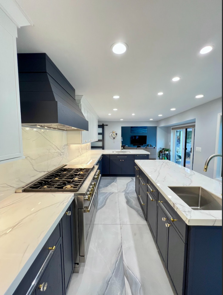 Inspiration for an expansive contemporary single-wall separate kitchen in Detroit with an undermount sink, flat-panel cabinets, granite benchtops, white splashback, granite splashback, panelled appliances, porcelain floors, with island, blue floor, white benchtop and blue cabinets.