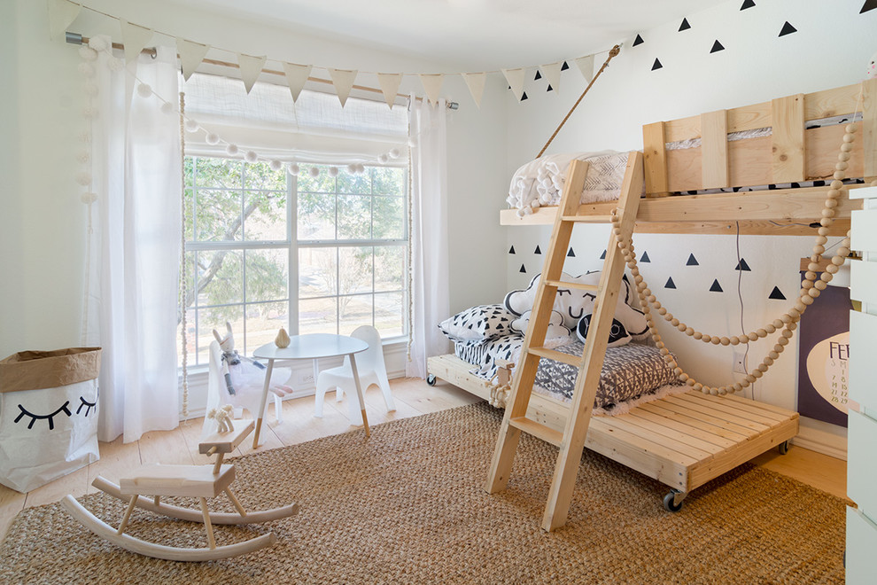 Inspiration for a small scandinavian gender-neutral kids' bedroom for kids 4-10 years old in Dallas with white walls and light hardwood floors.