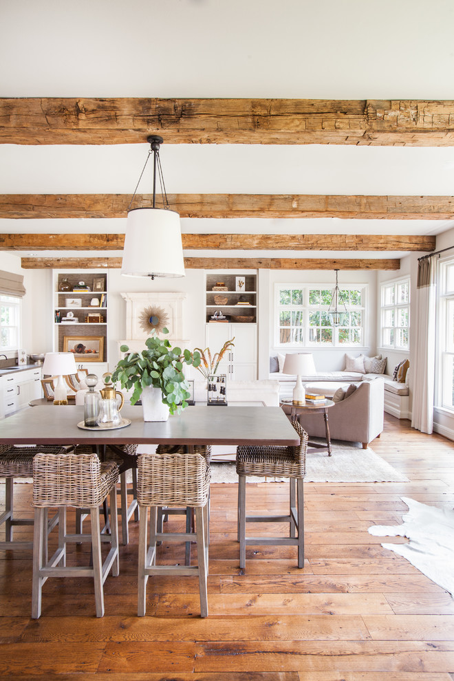 This is an example of a country open plan dining in Houston with medium hardwood floors.