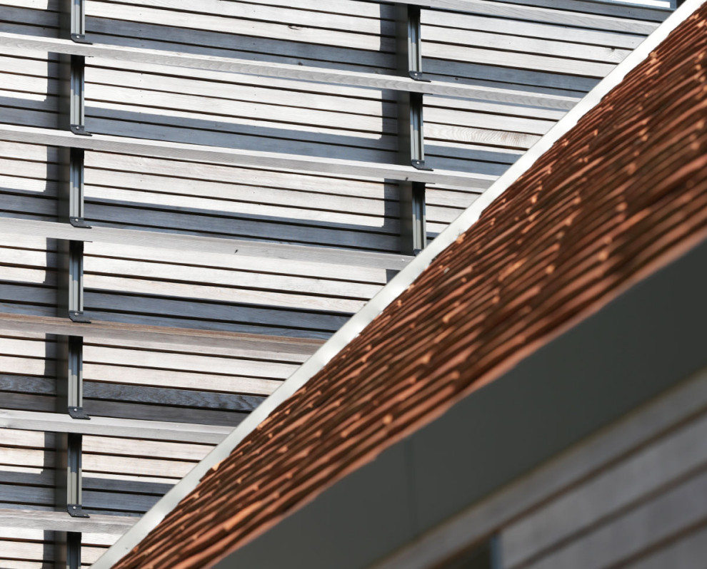 Design ideas for a large modern two floor house exterior in Kent.