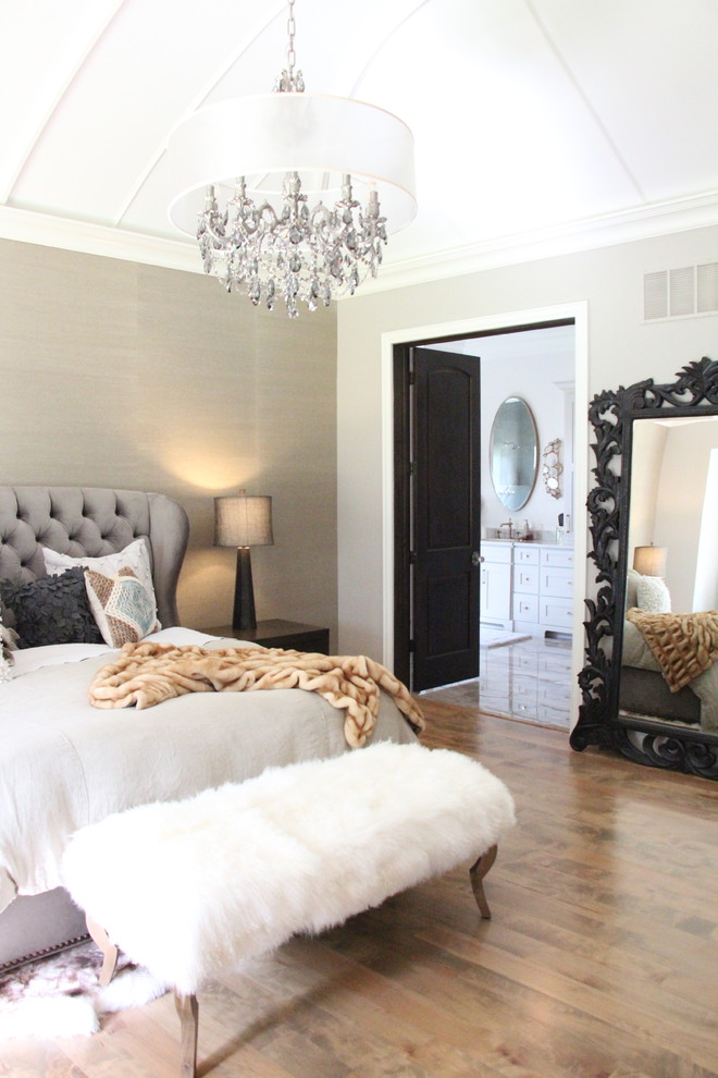 Photo of an expansive transitional master bedroom in St Louis with beige walls and medium hardwood floors.