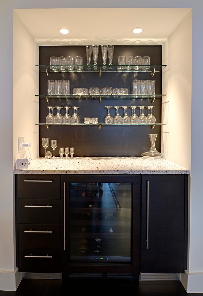 Design ideas for a mid-sized contemporary single-wall wet bar in Tampa with flat-panel cabinets, dark wood cabinets, quartz benchtops, an undermount sink, white splashback, subway tile splashback and porcelain floors.