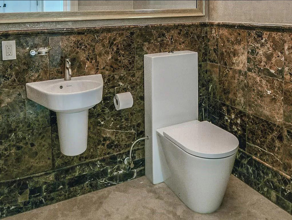 Photo of a small mediterranean powder room in Miami with a one-piece toilet, brown tile, marble, beige walls, marble floors, a wall-mount sink and beige floor.