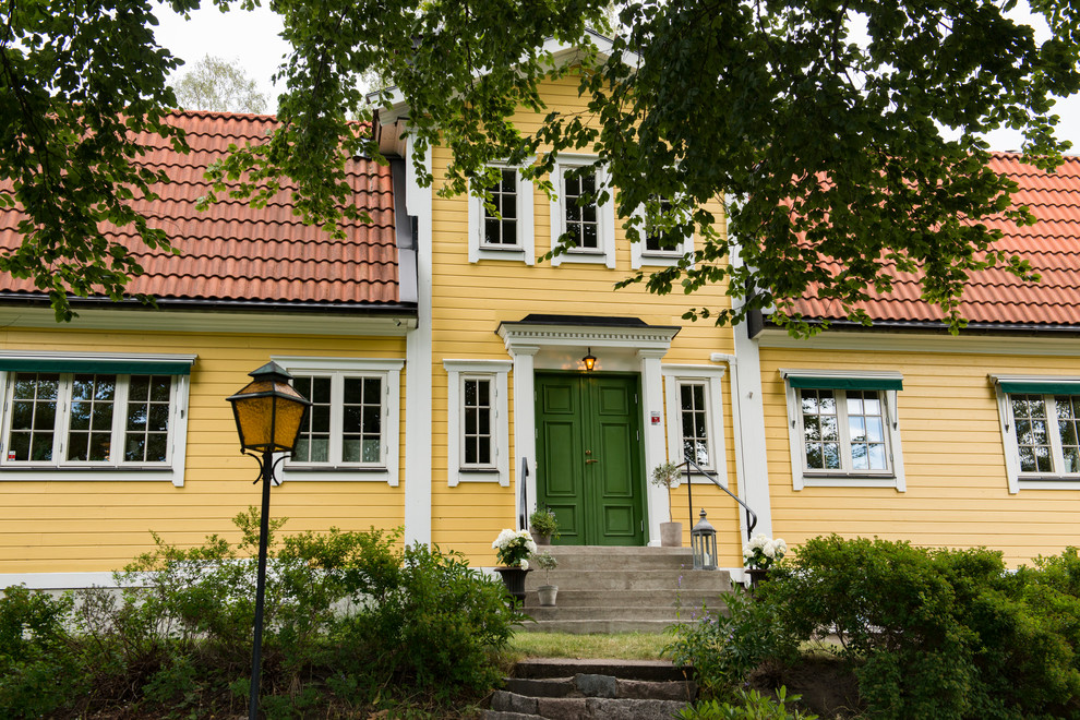 Inspiration for a country exterior in Stockholm with wood siding.