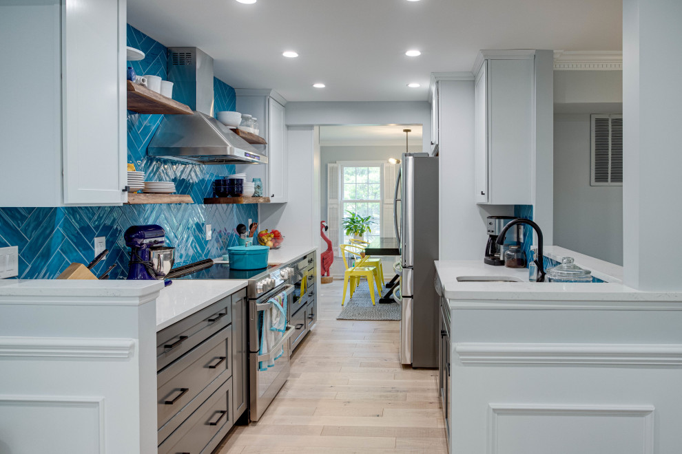 Inspiration for a mid-sized transitional galley kitchen remodel in DC Metro with an undermount sink, shaker cabinets, quartz countertops, blue backsplash, stainless steel appliances and no island