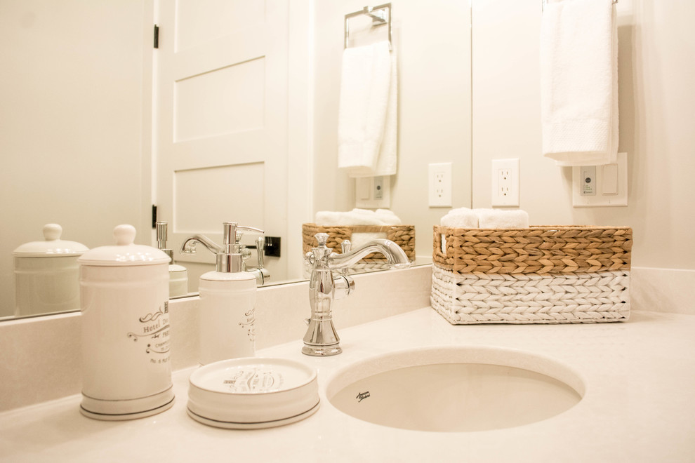 Inspiration for a mid-sized transitional master gray tile and porcelain tile porcelain tile and gray floor freestanding bathtub remodel in Calgary with recessed-panel cabinets, black cabinets, gray walls, an undermount sink, quartz countertops and a hinged shower door