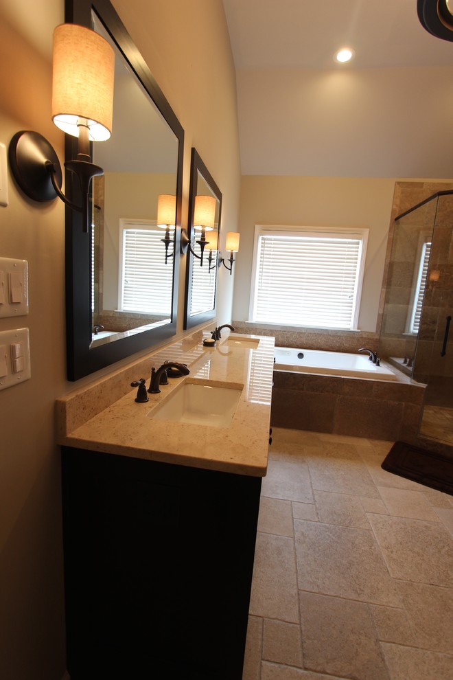 Design ideas for a large traditional master bathroom in Atlanta with an undermount sink, shaker cabinets, dark wood cabinets, a drop-in tub, a corner shower, a one-piece toilet, brown tile, stone tile, brown walls and porcelain floors.
