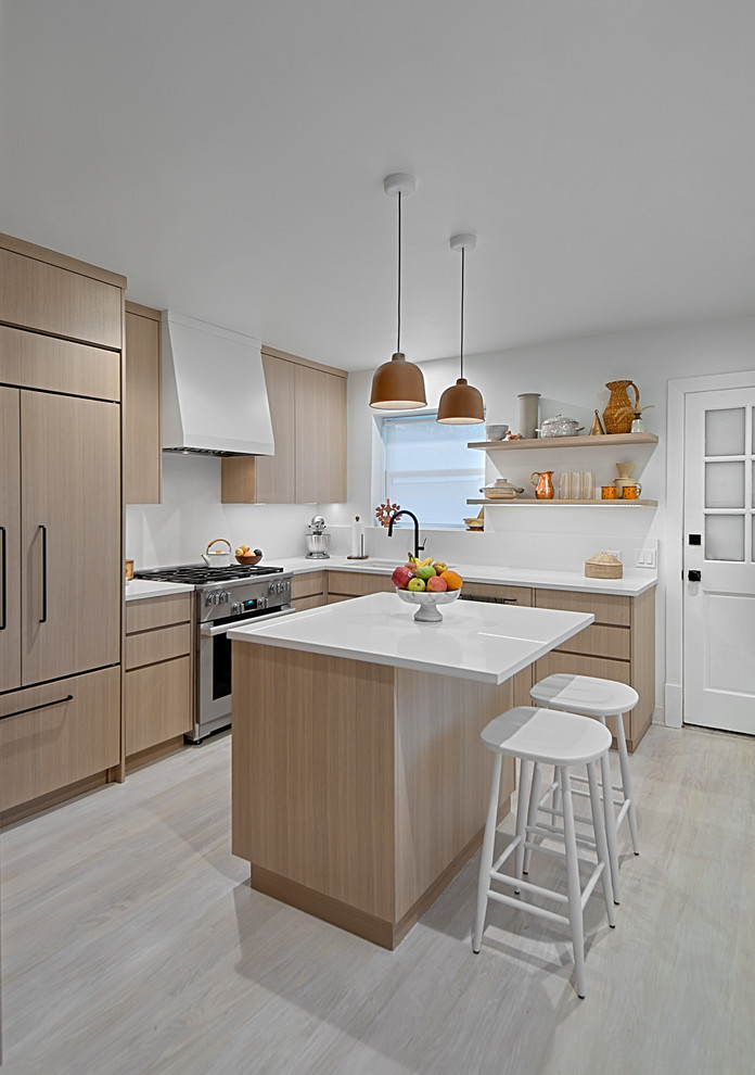 Design ideas for a small contemporary l-shaped kitchen in Chicago with an undermount sink, flat-panel cabinets, light wood cabinets, quartz benchtops, white splashback, stone slab splashback, stainless steel appliances, light hardwood floors, with island, grey floor and white benchtop.