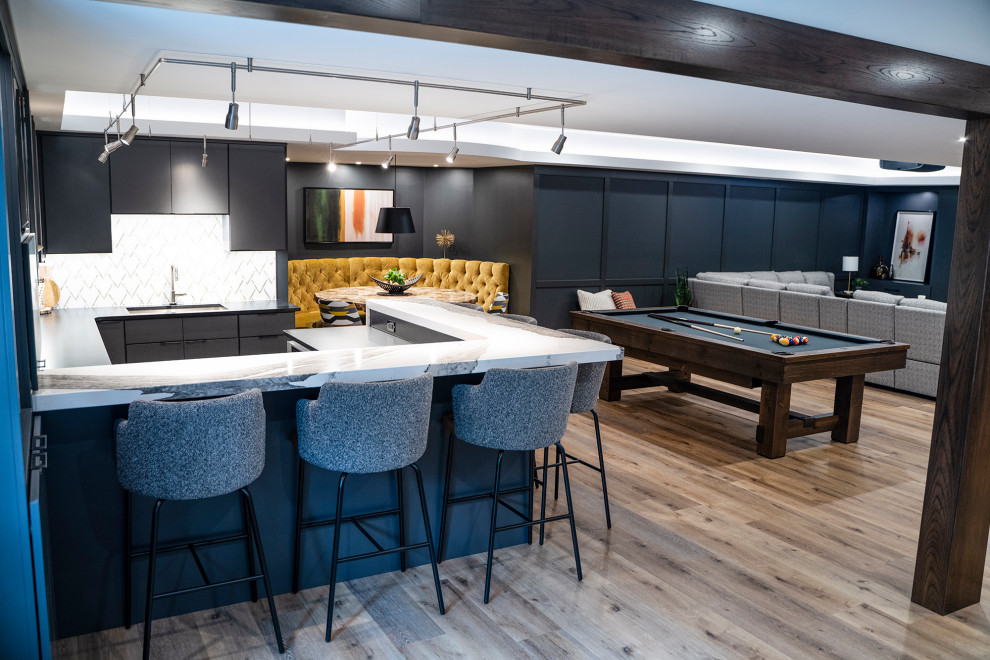 Basement - large modern look-out vinyl floor and wallpaper basement idea in Other with a bar, black walls, a standard fireplace and a metal fireplace
