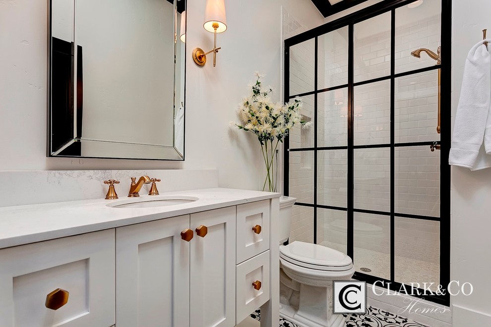 Mid-sized country 3/4 bathroom in Boise with shaker cabinets, white cabinets, an alcove shower, a two-piece toilet, black and white tile, porcelain tile, white walls, porcelain floors, an undermount sink and engineered quartz benchtops.