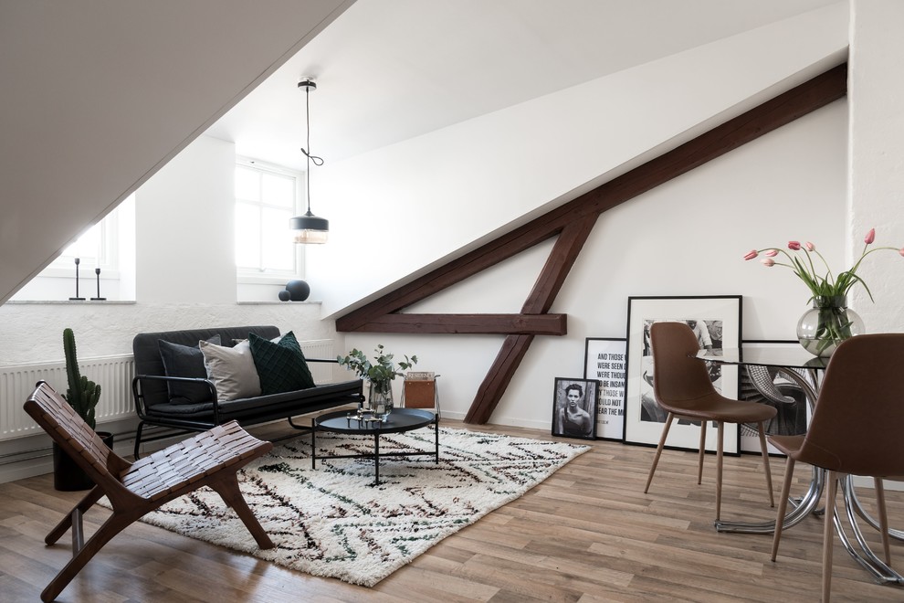 Scandinavian open concept living room in Other with white walls, light hardwood floors and brown floor.