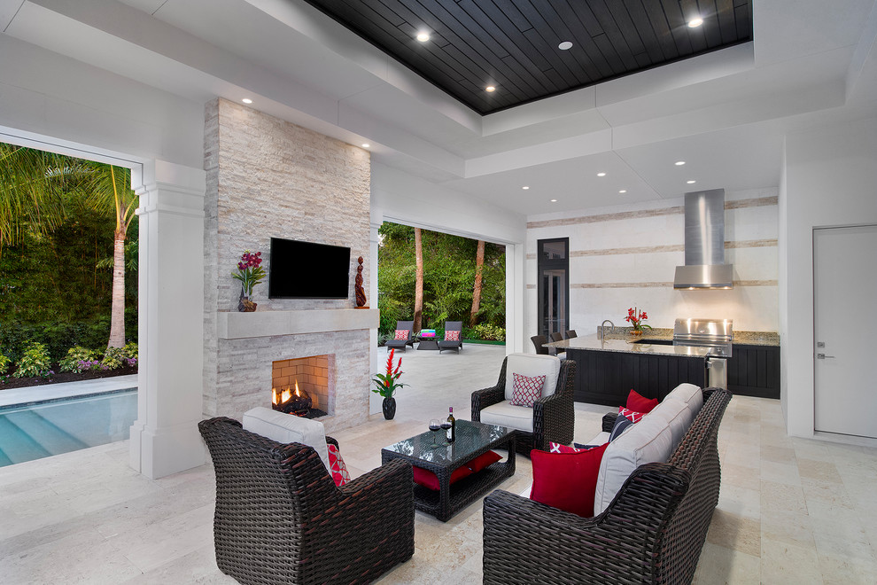 Expansive transitional backyard patio in Miami with an outdoor kitchen.