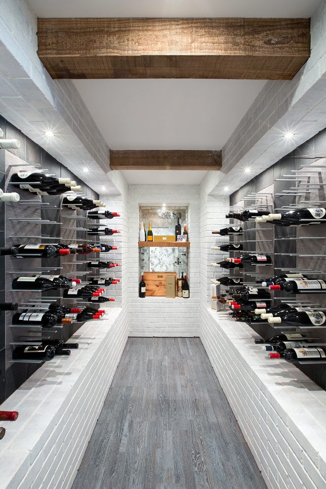 Photo of a mid-sized contemporary wine cellar in Vancouver with storage racks.