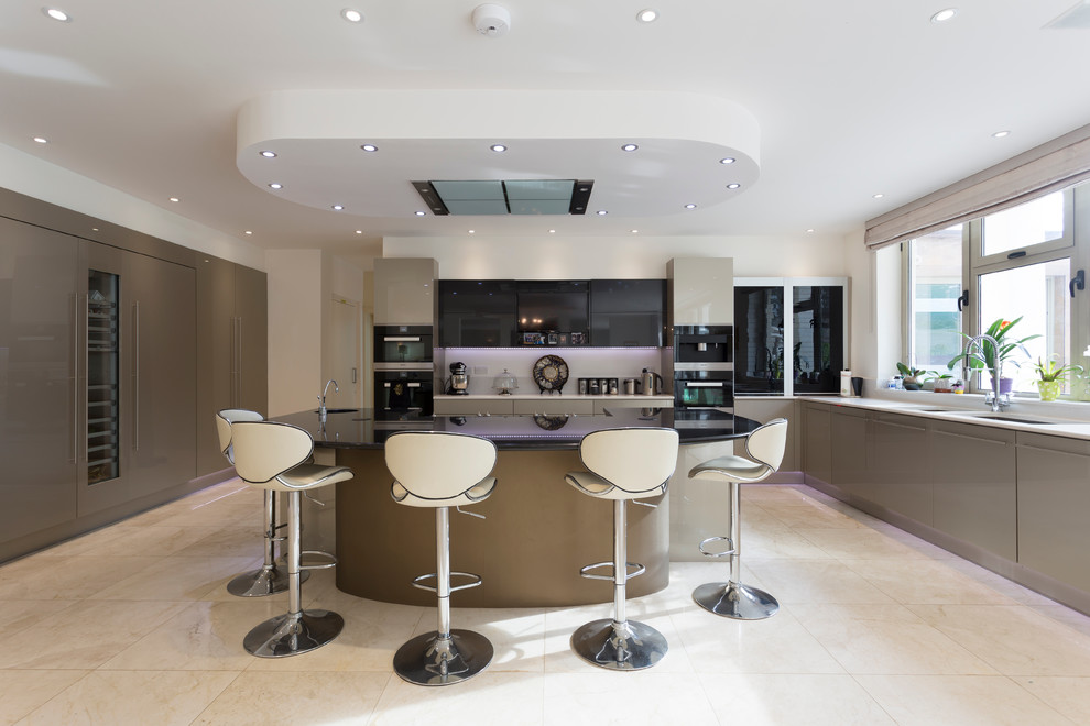 Large contemporary u-shaped open plan kitchen in London with a double-bowl sink, flat-panel cabinets, stainless steel cabinets, granite benchtops, glass sheet splashback, marble floors and with island.