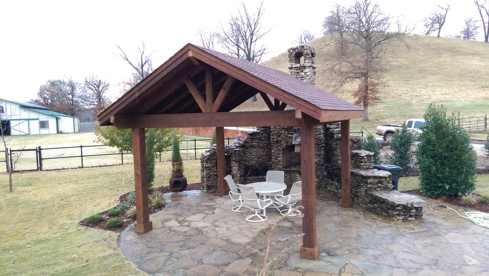 Inspiration for a rustic backyard stone and kidney-shaped lap pool fountain remodel