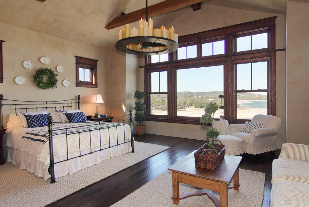 Photo of a traditional bedroom in Austin with beige walls and dark hardwood floors.