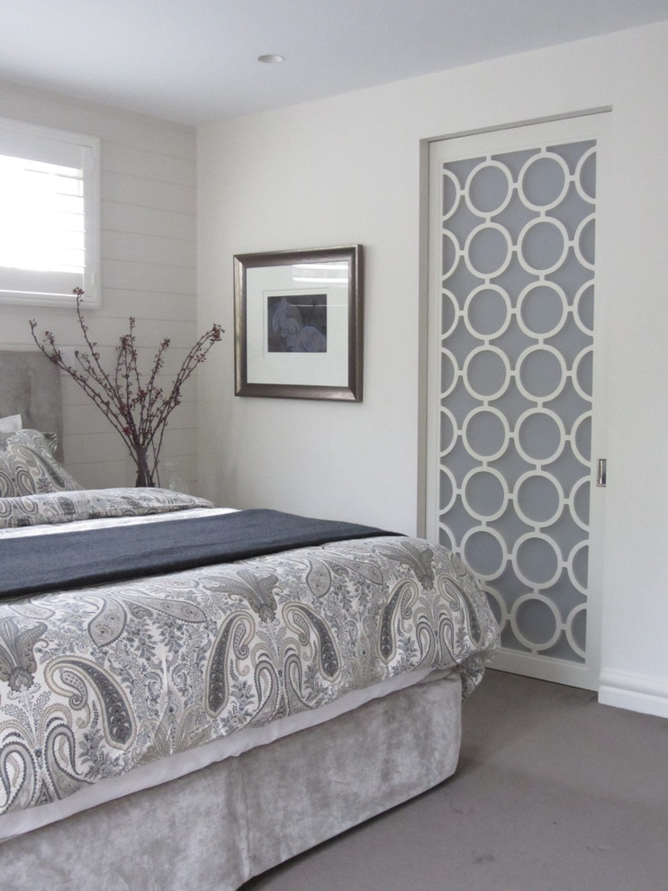 Inspiration for a traditional bedroom in Sydney with white walls and carpet.